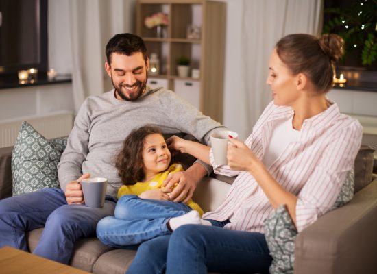 a happy family sitting together on a couch