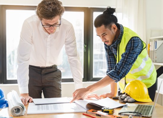 architect explaining client demand plan of construction on the table to contractor.