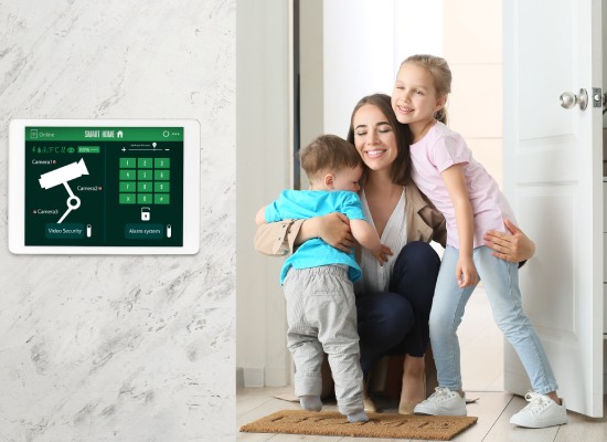 Happy children and their mother in hall under protection of smart home security system