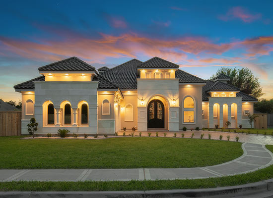 Mission Texas custim home. A picturesque house framed by a colorful sunset, highlighting the beauty of the evening sky.