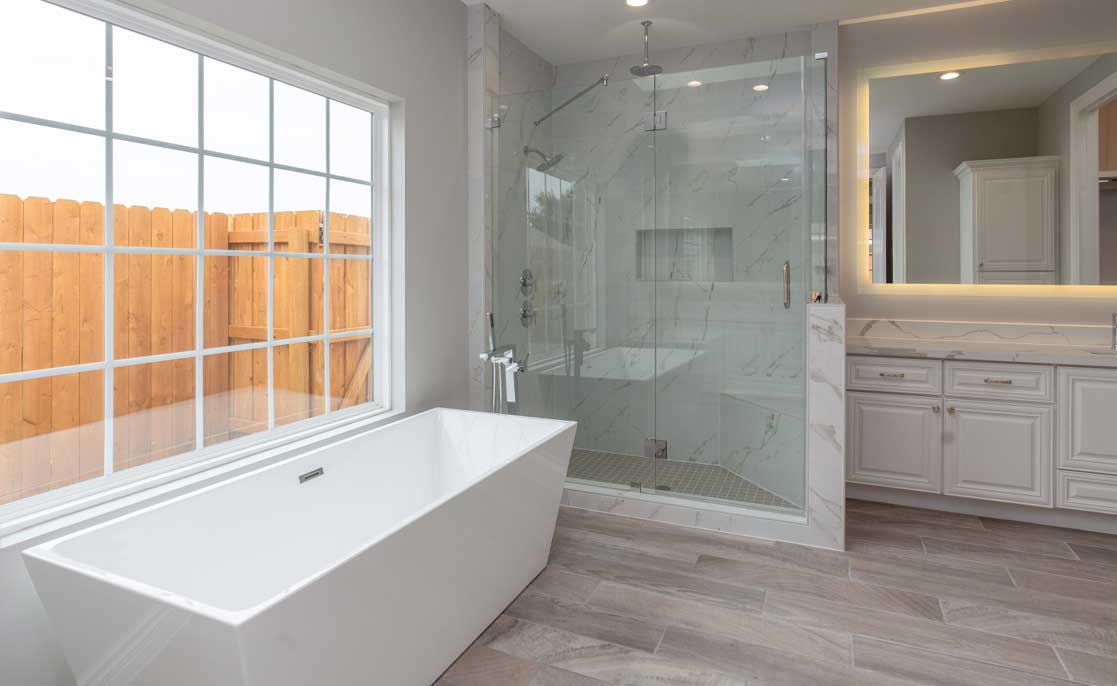 Spacious kitchen featuring hardwood floors and large windows, creating a bright and inviting atmosphere.